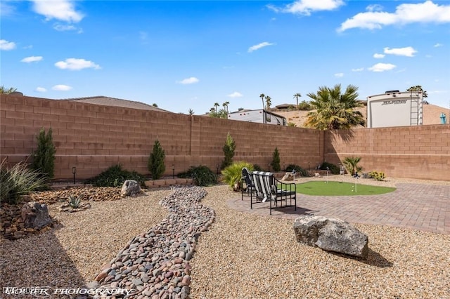 942 Shadow Hawk Rdg, Mesquite, NV 89027 - fenced backyard with a putting area and a patio