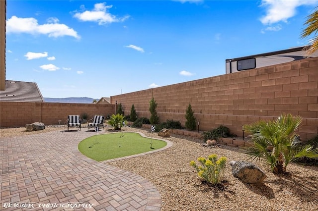 942 Shadow Hawk Rdg, Mesquite, NV 89027 - fenced backyard featuring a putting green and a patio area