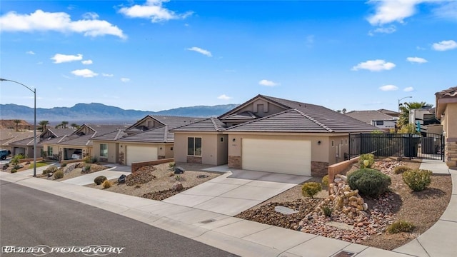942 Shadow Hawk Rdg, Mesquite, NV 89027 - ranch-style home featuring a mountain view, stucco siding, fence, and a garage