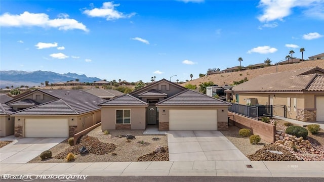 942 Shadow Hawk Rdg, Mesquite, NV 89027 - ranch-style house with driveway, stone siding, stucco siding, and a garage
