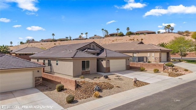 942 Shadow Hawk Rdg, Mesquite, NV 89027 - single story home featuring stone siding, stucco siding, a tile roof, and concrete driveway