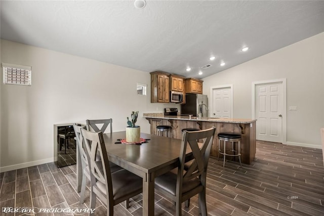 942 Shadow Hawk Rdg, Mesquite, NV 89027 - dining area featuring baseboards, wood finish floors, lofted ceiling, and recessed lighting