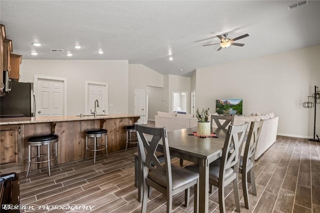 942 Shadow Hawk Rdg, Mesquite, NV 89027 - dining area with a ceiling fan, wood finish floors, vaulted ceiling, baseboards, and recessed lighting