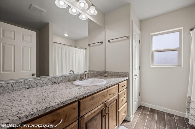 942 Shadow Hawk Rdg, Mesquite, NV 89027 - full bath with baseboards, vanity, and wood tiled floors