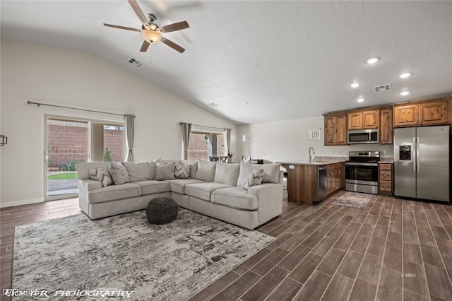 942 Shadow Hawk Rdg, Mesquite, NV 89027 - living room featuring ceiling fan, vaulted ceiling, recessed lighting, dark wood-type flooring, and baseboards