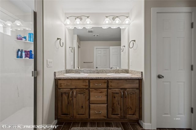 942 Shadow Hawk Rdg, Mesquite, NV 89027 - full bath with double vanity, wood finished floors, a stall shower, and baseboards