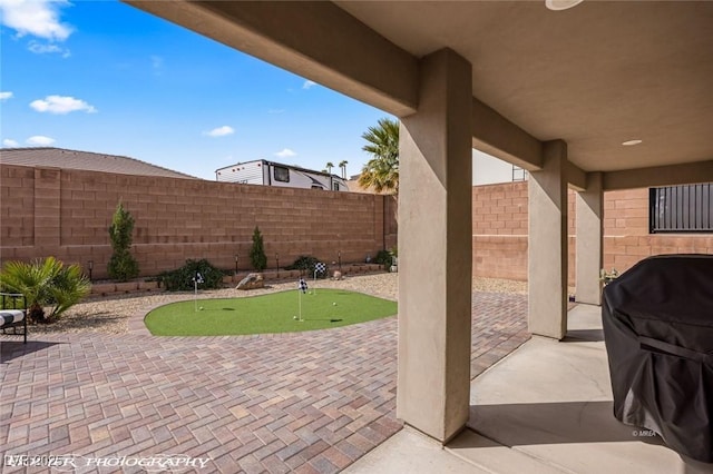 942 Shadow Hawk Rdg, Mesquite, NV 89027 - view of patio featuring a putting green, a fenced backyard, and area for grilling