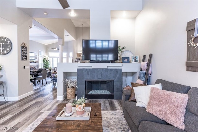 53 Grossinger Ct, Henderson, NV 89074 - living room with a ceiling fan, wood finished floors, baseboards, and a tile fireplace