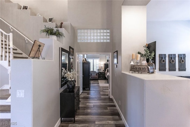 53 Grossinger Ct, Henderson, NV 89074 - corridor with stairs, a towering ceiling, dark wood-style flooring, and baseboards