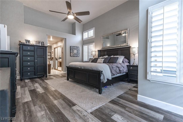 53 Grossinger Ct, Henderson, NV 89074 - bedroom featuring dark wood-style floors, baseboards, ensuite bathroom, and a ceiling fan