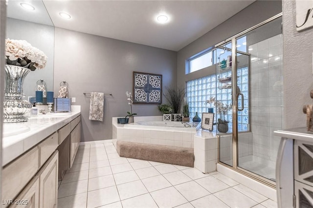 53 Grossinger Ct, Henderson, NV 89074 - bathroom featuring a bath, a shower stall, tile patterned floors, double vanity, and baseboards