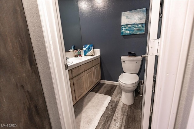 53 Grossinger Ct, Henderson, NV 89074 - bathroom with wood finished floors, vanity, toilet, and baseboards