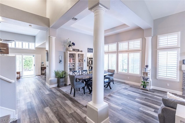 53 Grossinger Ct, Henderson, NV 89074 - dining area with ornate columns, wood finished floors, baseboards, and a tray ceiling
