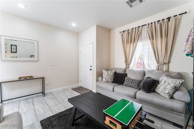 living room featuring recessed lighting and baseboards