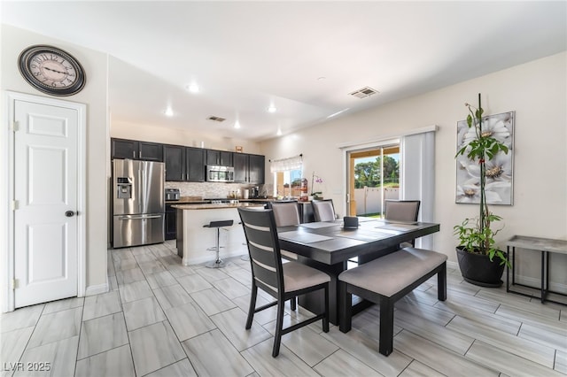 dining area featuring baseboards and recessed lighting