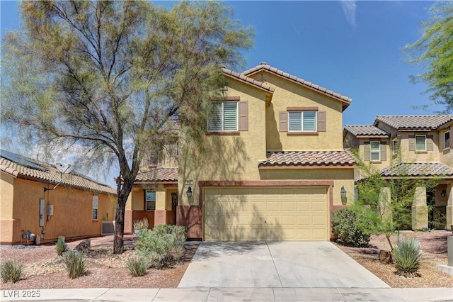 952 Crescent Falls St, Henderson, NV 89011 - mediterranean / spanish-style house featuring concrete driveway, stucco siding, a tile roof, and a garage