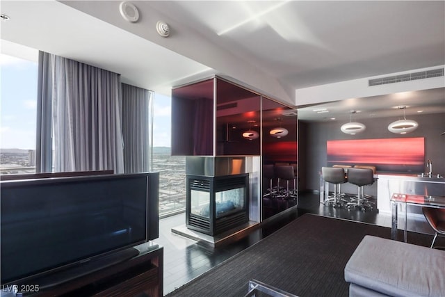 reception featuring floor to ceiling windows and a multi sided fireplace
