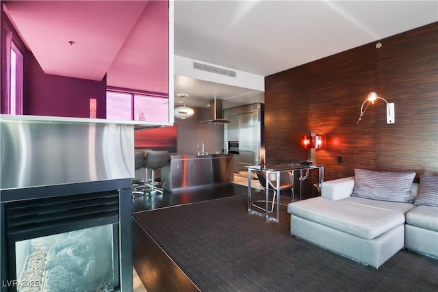 4381 W Flamingo Rd Unit 2122, Las Vegas, NV 89103 - living room featuring wood walls