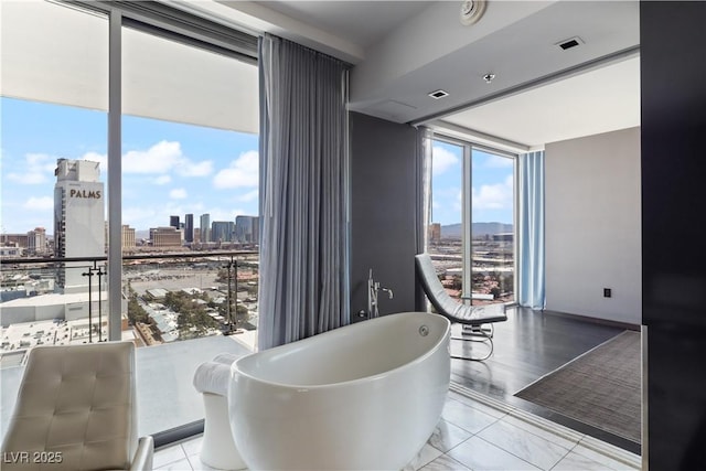 4381 W Flamingo Rd Unit 2122, Las Vegas, NV 89103 - dining space featuring a skyline view, a wall of windows, and marble look tiles