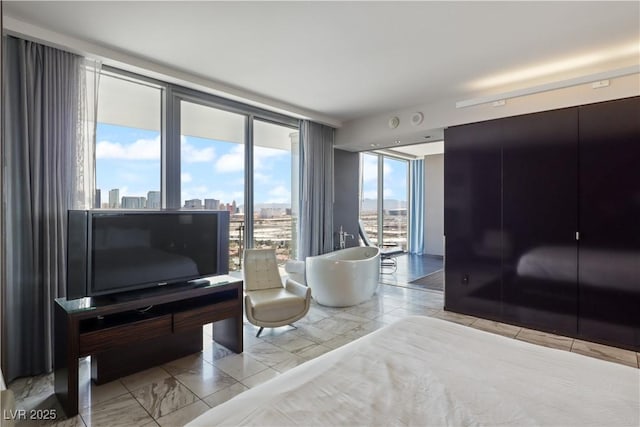 living area with light marble finish floors and expansive windows