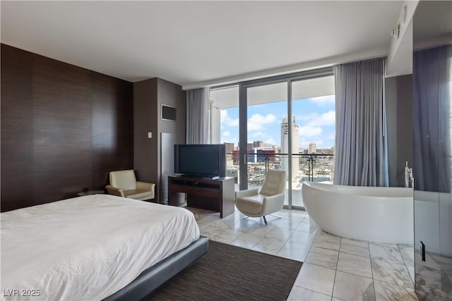 4381 W Flamingo Rd Unit 2122, Las Vegas, NV 89103 - bedroom with access to exterior, floor to ceiling windows, and light marble finish flooring
