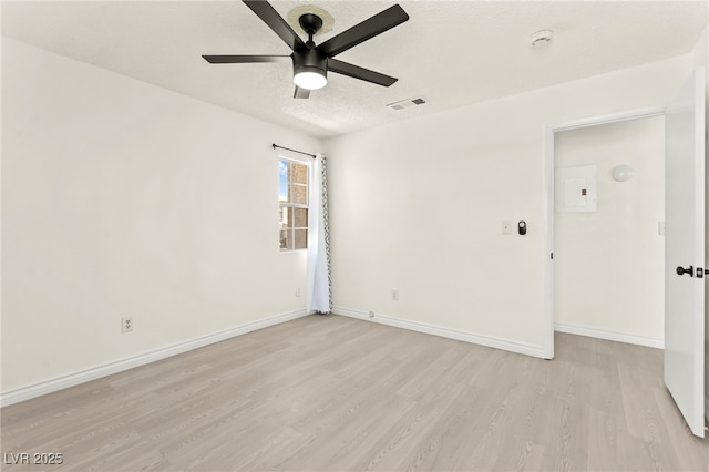 unfurnished room with a ceiling fan, light wood finished floors, baseboards, a textured ceiling, and a smoke detector