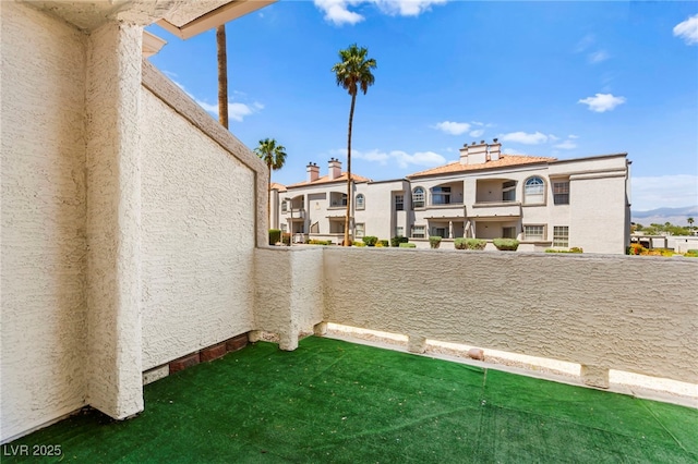 view of yard with a balcony