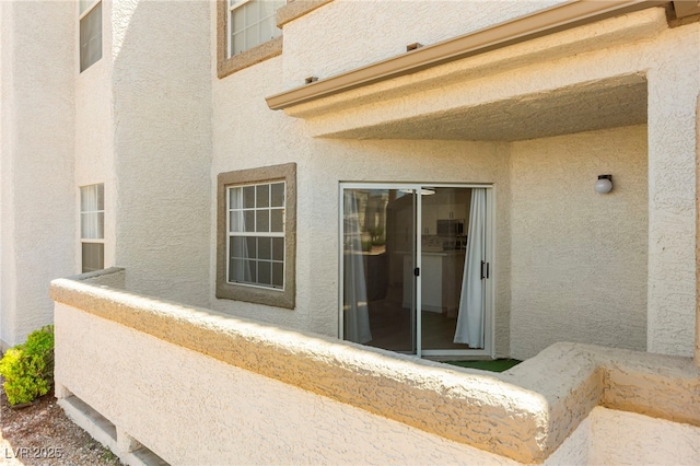 entrance to property featuring stucco siding
