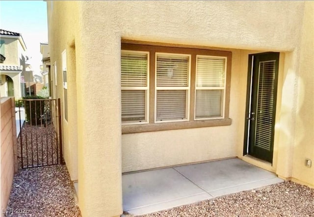 7563 Captain Lord Ct, Las Vegas, NV 89166 - entrance to property with stucco siding and a patio