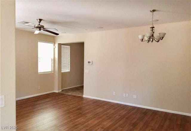 7563 Captain Lord Ct, Las Vegas, NV 89166 - spare room with dark wood-type flooring, a ceiling fan, a chandelier, and baseboards