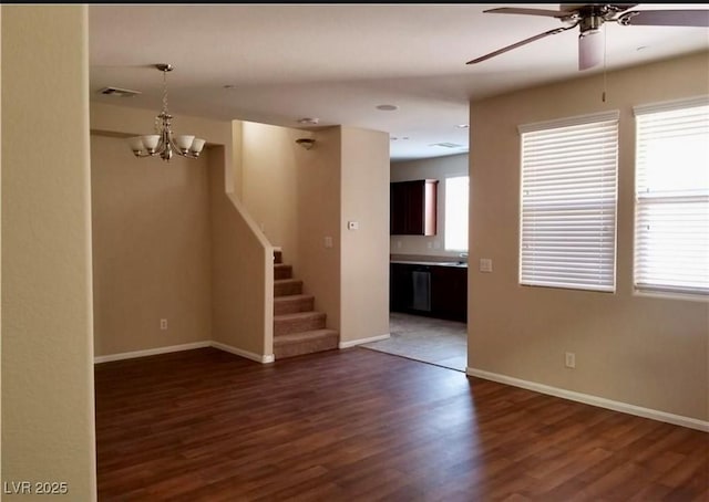 7563 Captain Lord Ct, Las Vegas, NV 89166 - unfurnished living room featuring ceiling fan, dark wood-style flooring, a chandelier, baseboards, and stairway