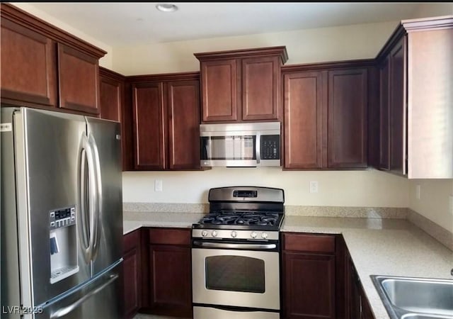 7563 Captain Lord Ct, Las Vegas, NV 89166 - kitchen featuring stainless steel appliances, light countertops, and a sink
