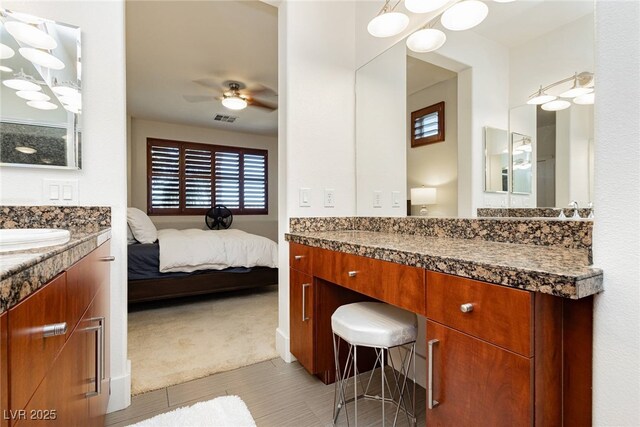 full bath with ensuite bathroom, a ceiling fan, and vanity