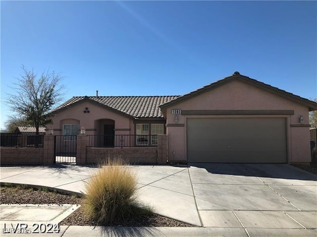 1083 Sterling Peak St, Las Vegas, NV 89110 - view of front of house with stucco siding, driveway, a fenced front yard, an attached garage, and a tiled roof