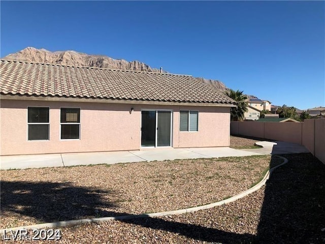 1083 Sterling Peak St, Las Vegas, NV 89110 - rear view of property with a tiled roof, a fenced backyard, and stucco siding