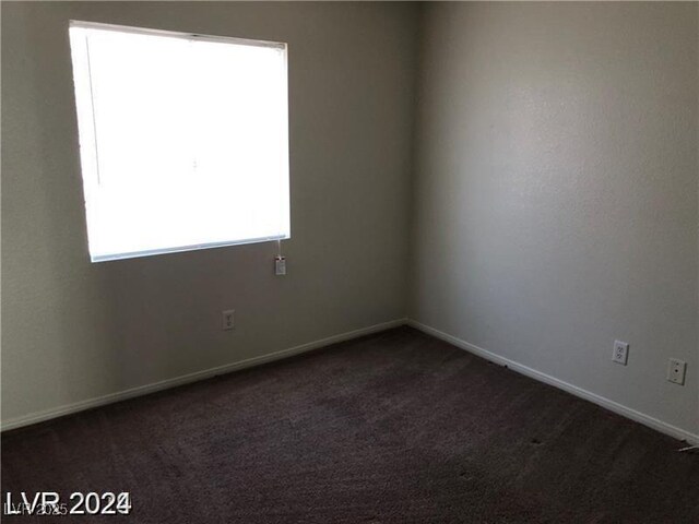 1083 Sterling Peak St, Las Vegas, NV 89110 - unfurnished room featuring dark colored carpet and baseboards
