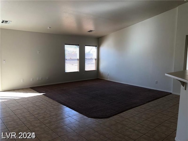 1083 Sterling Peak St, Las Vegas, NV 89110 - empty room featuring dark carpet, baseboards, and dark tile patterned flooring