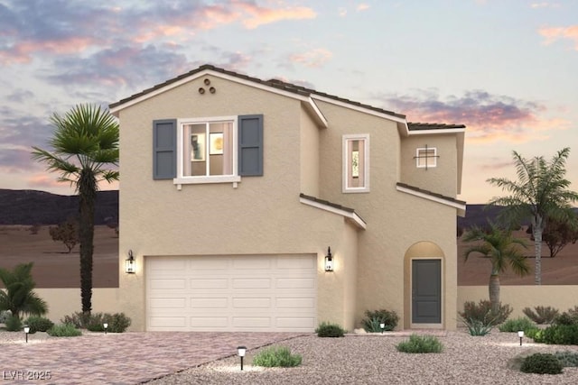 9952 Ruby Dome Ave, Las Vegas, NV 89178 - view of front of house with an attached garage, stucco siding, and decorative driveway