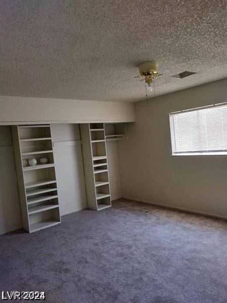 unfurnished bedroom featuring carpet floors and a textured ceiling