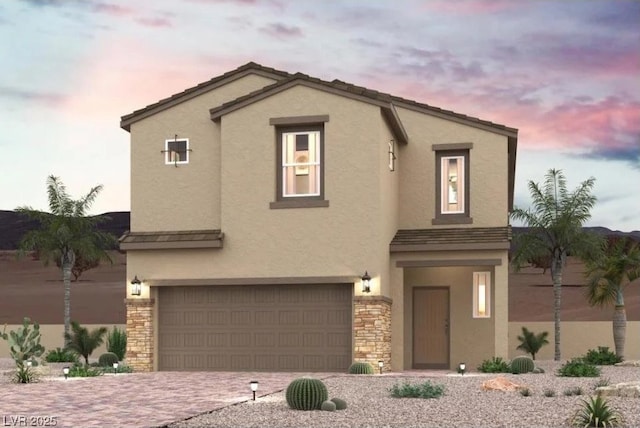 9958 Ruby Dome Ave, Las Vegas, NV 89178 - view of front of home featuring stucco siding, a garage, stone siding, and driveway