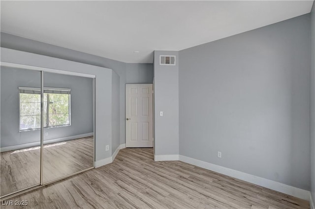 1501 Oscar Ct Unit 101, Las Vegas, NV 89146 - unfurnished bedroom featuring wood finished floors, baseboards, and a closet
