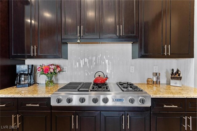 7719 Villa Montara St, Las Vegas, NV 89123 - kitchen with stainless steel gas stovetop, tasteful backsplash, dark brown cabinets, and light stone countertops