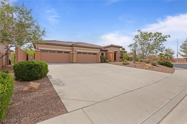 7719 Villa Montara St, Las Vegas, NV 89123 - mediterranean / spanish house featuring stucco siding, a tile roof, concrete driveway, an attached garage, and fence