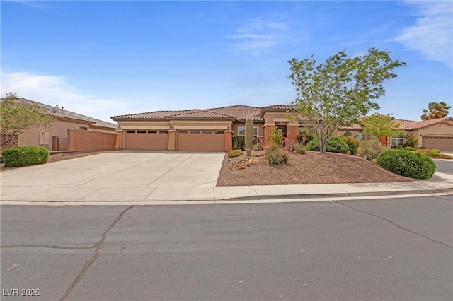7719 Villa Montara St, Las Vegas, NV 89123 - view of front facade with an attached garage, a tiled roof, concrete driveway, stucco siding, and fence