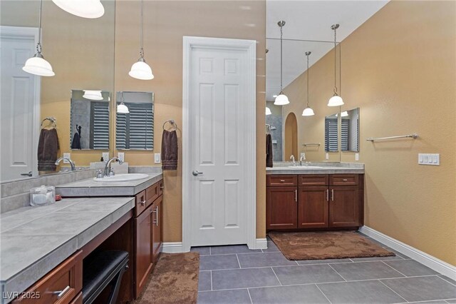 7719 Villa Montara St, Las Vegas, NV 89123 - full bath featuring tile patterned flooring, baseboards, and two vanities