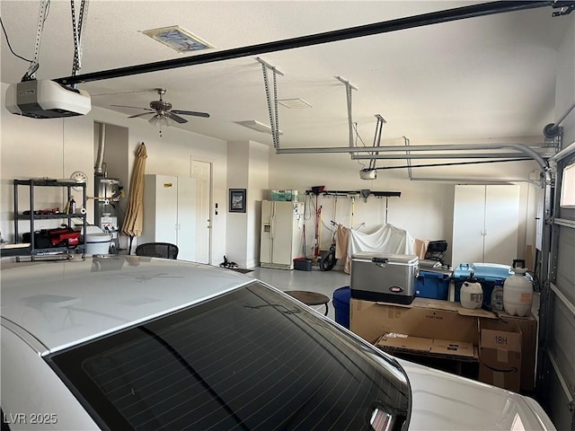 7719 Villa Montara St, Las Vegas, NV 89123 - garage with white refrigerator with ice dispenser, a garage door opener, ceiling fan, and secured water heater