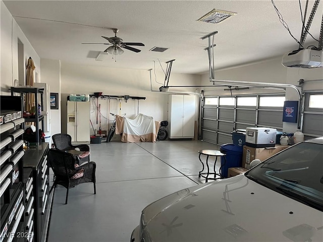 7719 Villa Montara St, Las Vegas, NV 89123 - garage featuring a garage door opener, white fridge with ice dispenser, and ceiling fan