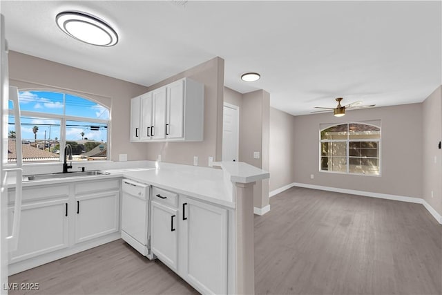 4324 W Lake Mead Blvd Unit 202, Las Vegas, NV 89108 - kitchen featuring a sink, dishwasher, light wood-type flooring, ceiling fan, and a peninsula
