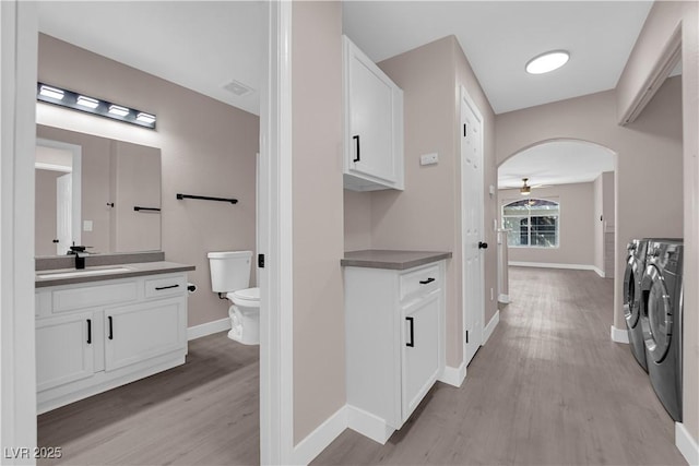 4324 W Lake Mead Blvd Unit 202, Las Vegas, NV 89108 - clothes washing area with separate washer and dryer, a sink, light wood finished floors, and baseboards