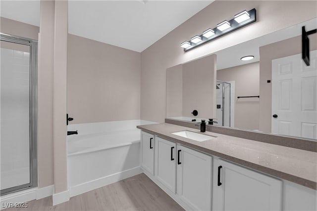 4324 W Lake Mead Blvd Unit 202, Las Vegas, NV 89108 - bathroom with a shower stall, a garden tub, vanity, and wood finished floors